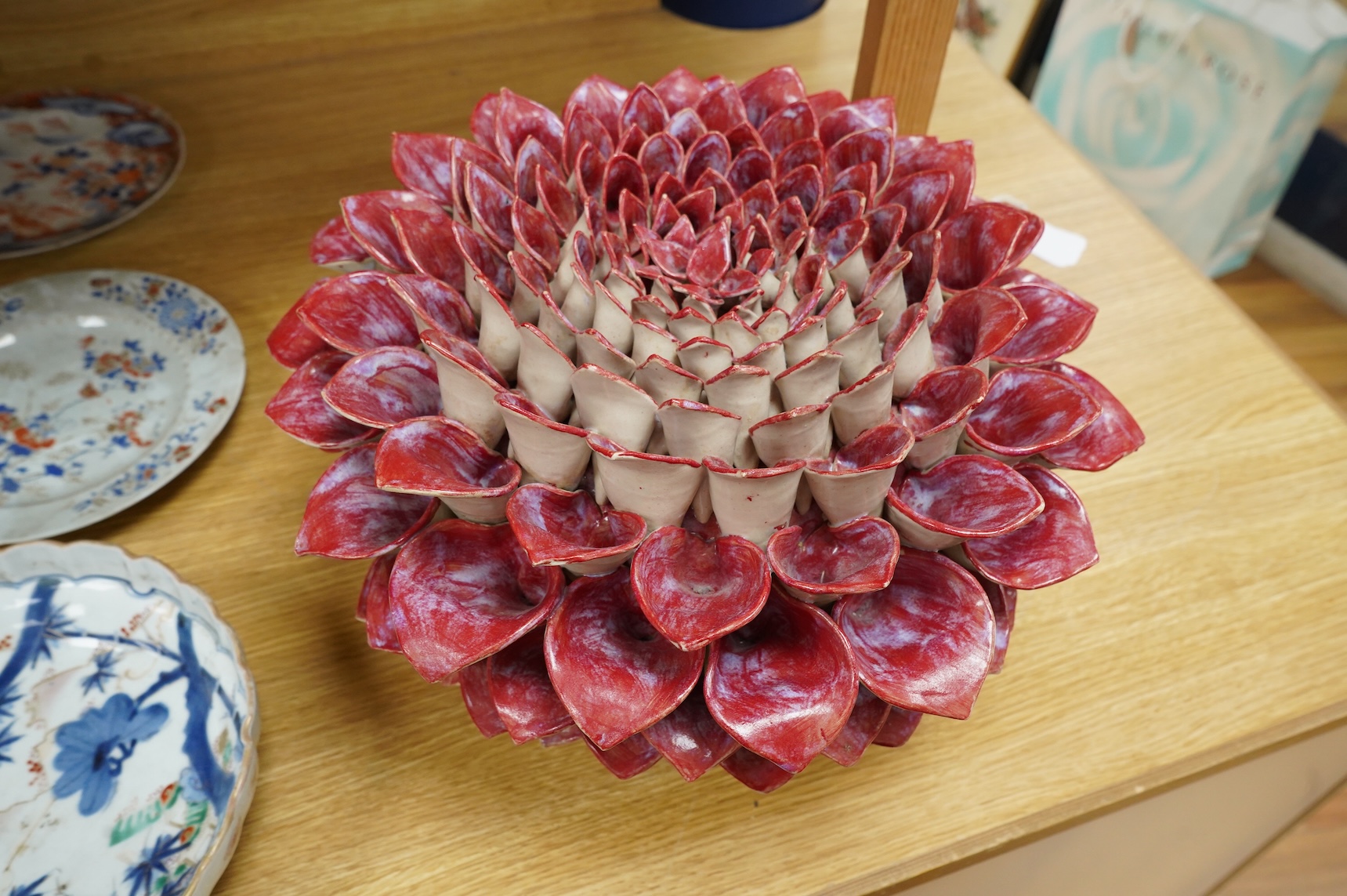 Frances Doherty, a Bishop's Pom Pom ceramic sculpture, with red glaze, 40cm wide